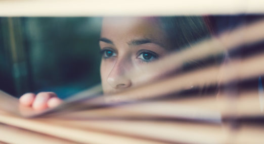 A woman looks out of a window