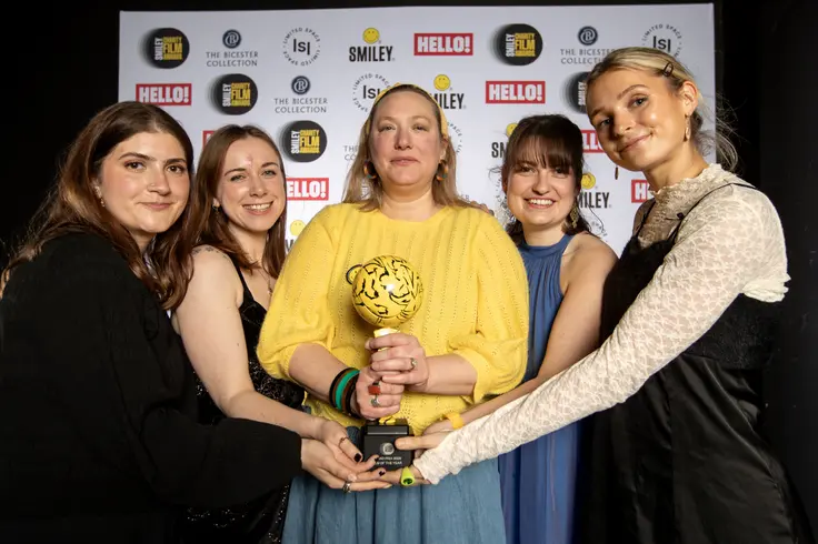 Refuge staff at the Smiley Film Awards holding the trophy